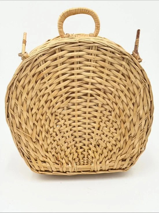 A Cute, charming vintage shell-shaped rattan storage basket with a front handle.
