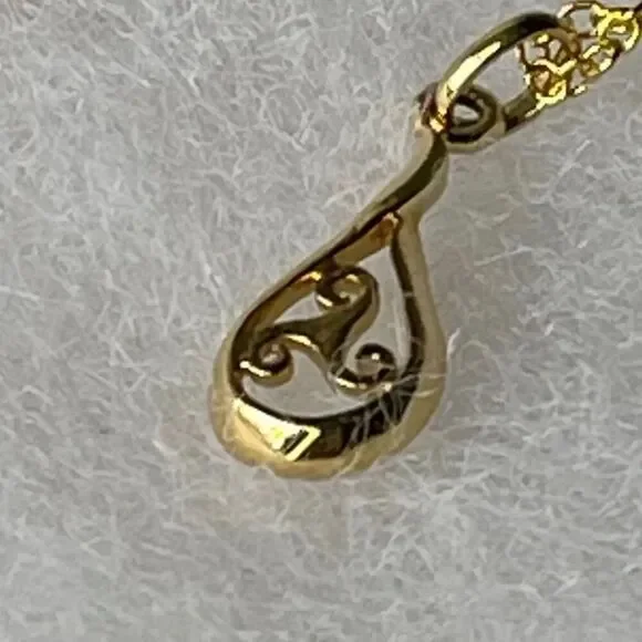 Sterling silver gold plated open work teardrop pendant and chain.