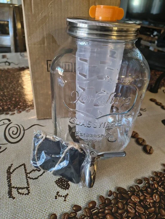 Glass Beverage Dispenser with Orange Infuser Lid and Silver Spigot