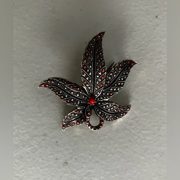 Vintage German intricate brooch maple leaf-shaped with small red crystals