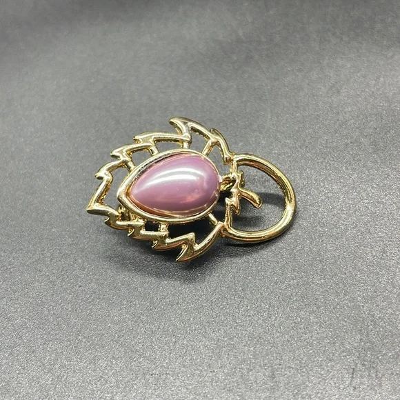 Gold plated brooch with a stone in the center | the stone color is a lavender
