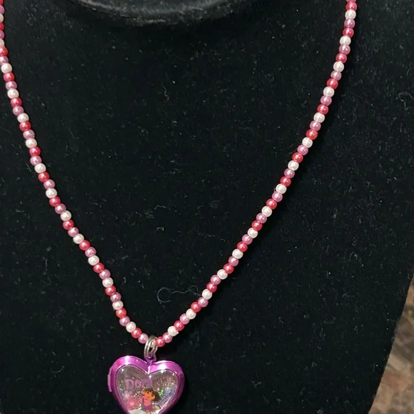 Pink and white beaded necklace with Dora the Explorer locket