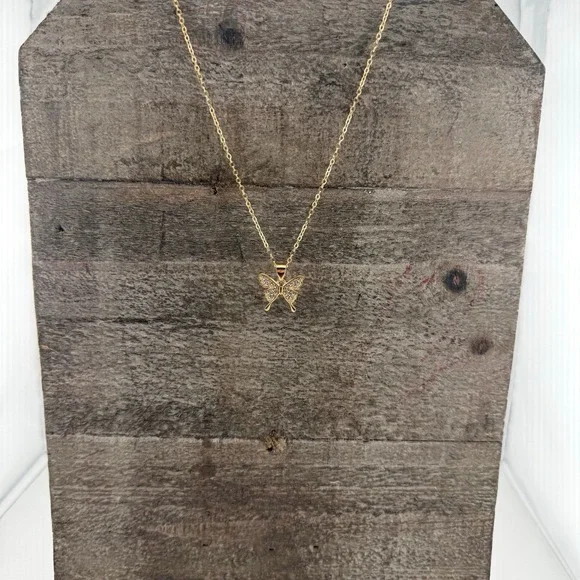 Goldtone butterfly pendant necklace with crystal inlay. 8