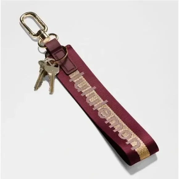 NEW Lululemon Never lost Keychain Wordmark Deep Luxe Gold Bone Burgundy Merlot