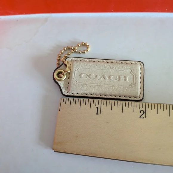 Coach White Pebbled‎ Leather Hang Tag in Cream with Gold Chain