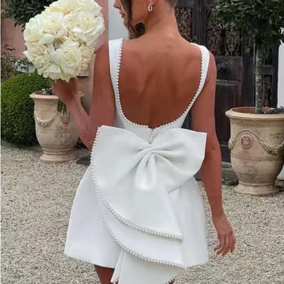 Elegant White Pearl-Trim Backbow Mini Dress
