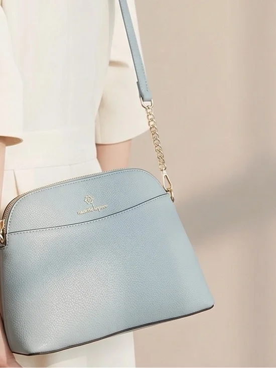 Elegant Light Blue Crossbody Bag with Gold Accents never used