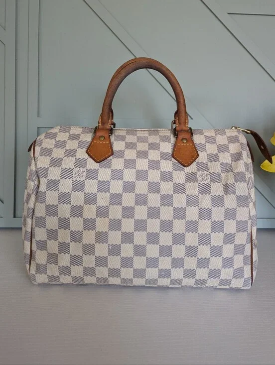 Louis Vuitton Speedyhandbag styled in the iconic Damier Azur canvas pattern.