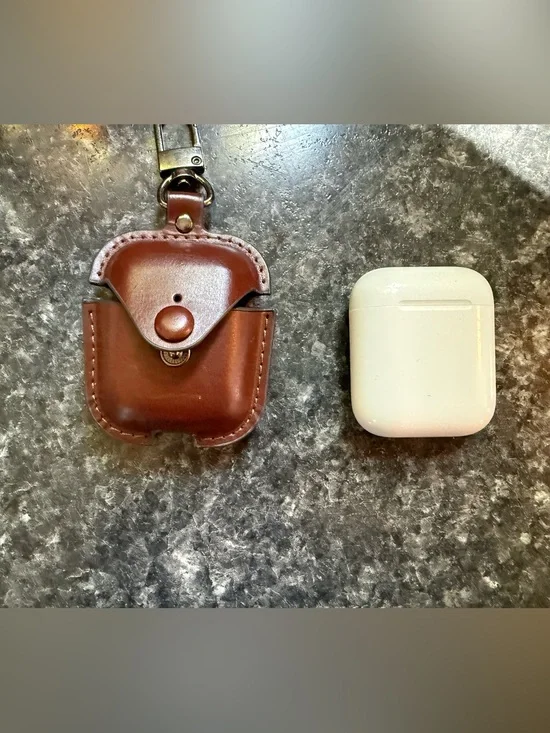 Apple AirPods and brown leather case