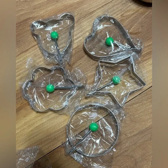 Set of 5 stainless steel Egg & Pancake Molds with Green Handles.
