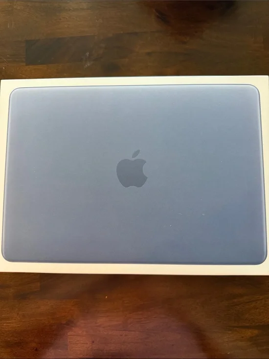Paper box of the Apple MacBook in Light Blue with Apple Logo