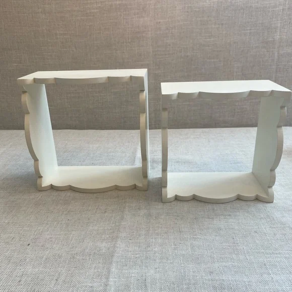 Two wall hanging white shadow boxes.
