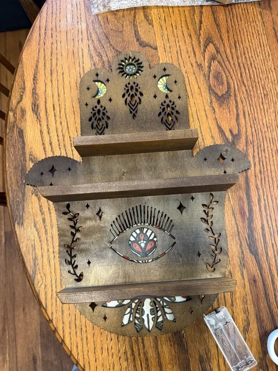 Handcrafted Brown Wooden Wall Shelf with Decorative Eye Motif that lights up
