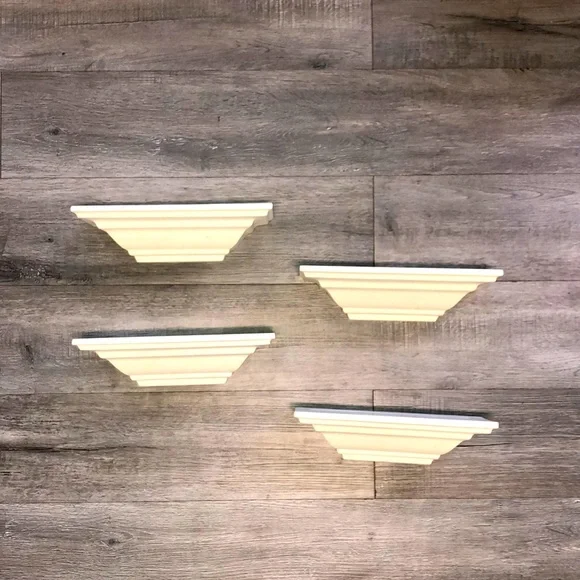 Four all white shelves with some light little scratches