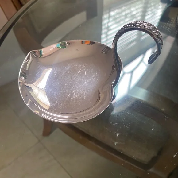 Ornate Silver Ladle with Intricate Handle