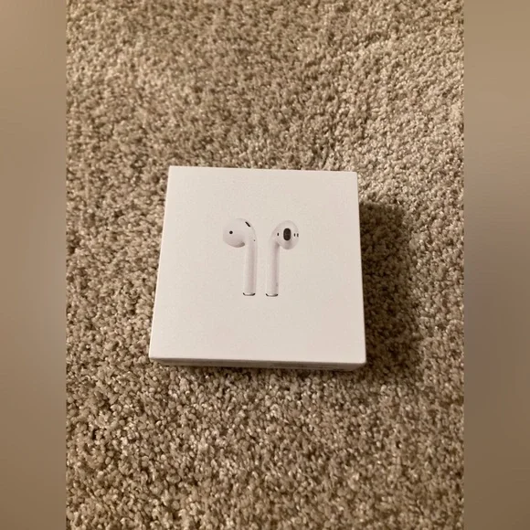 Apple AirPods with charging piece product box, instructions, and pamphlet