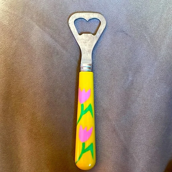 Decorative bottle opener with pink‎ tulip on a yellow background