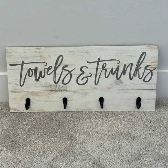 Wooden towels and trunks sign