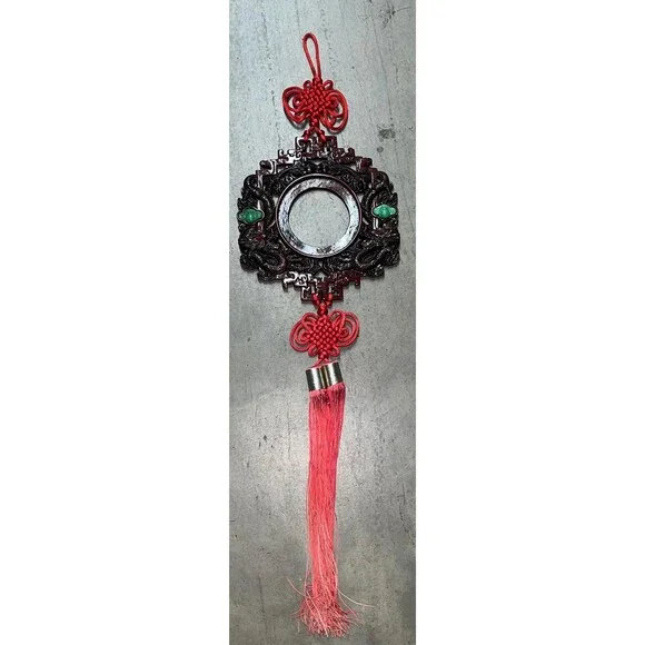 Chinese good luck wall hanging featuring a carved dragon design red knot tassel.