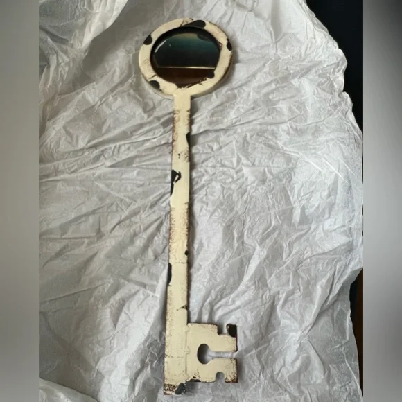 NWT Decorative metal key shaped mirror that hangs on a wall. Hook included.