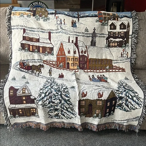 woven tapestry throw blanket featuring a winter village scene fringe edges