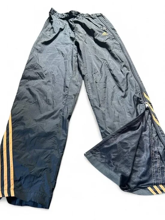 Adidas navy track pants with yellow stripes and zipper pockets size medium