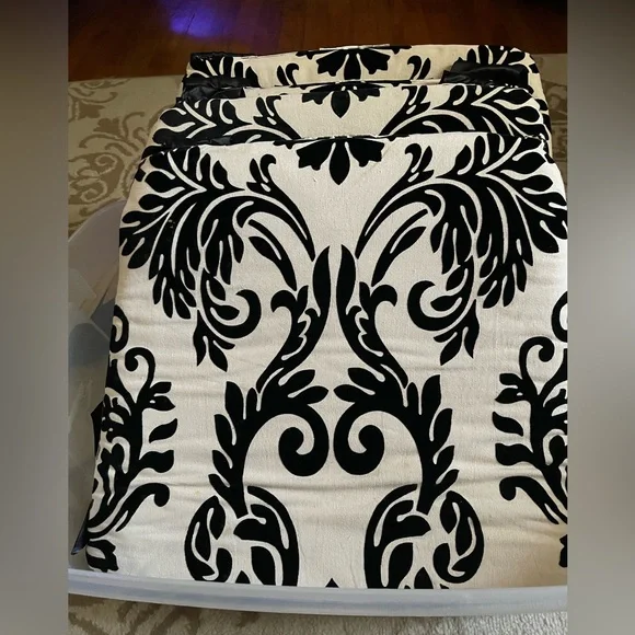 Chic Black and Cream padded chair covers with black satin ties.