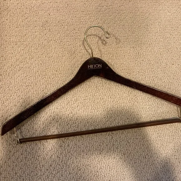 Vintage Hilton dark brown glossy wooden suit hanger. some scratches.