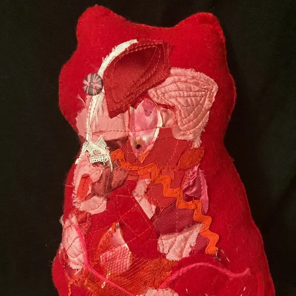 Felted cat pillow with apliqued and stitched designs. Vintage fabric and button.