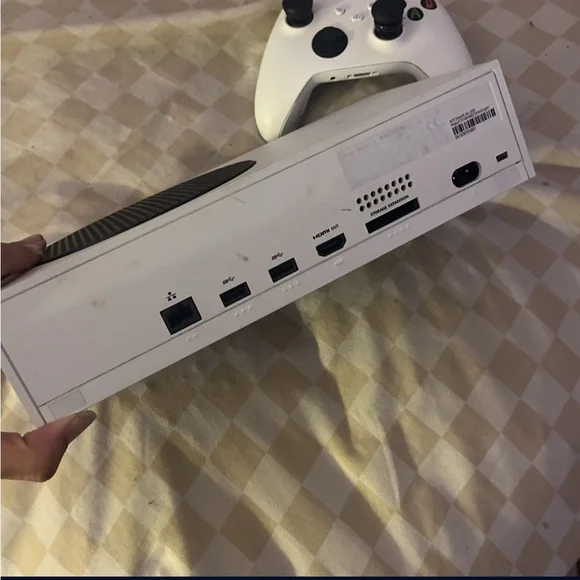 Sleek White Gaming Console with Controller and steering wheel shifter and pedals
