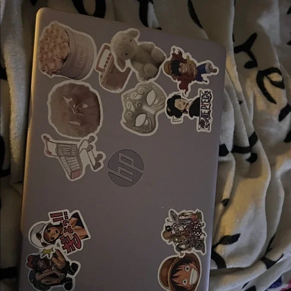 HP Laptop with Anime and Floral Stickers