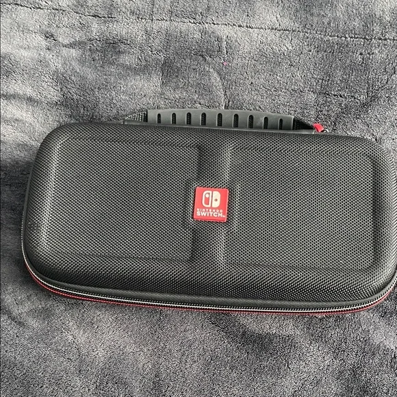 Nintendo Switch Black case with red and light grey accent stitching.