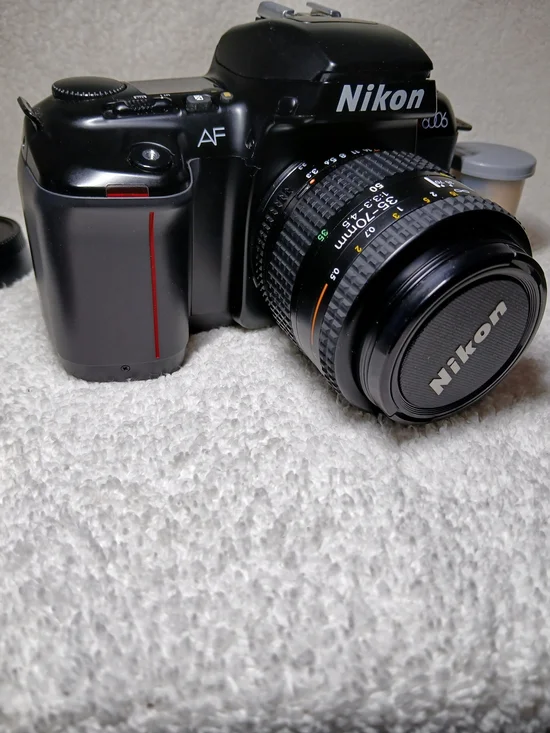 Nikon N6006 35mm autofocus SLR film camera. With Extra Lens and 2 Rolls Of Film.