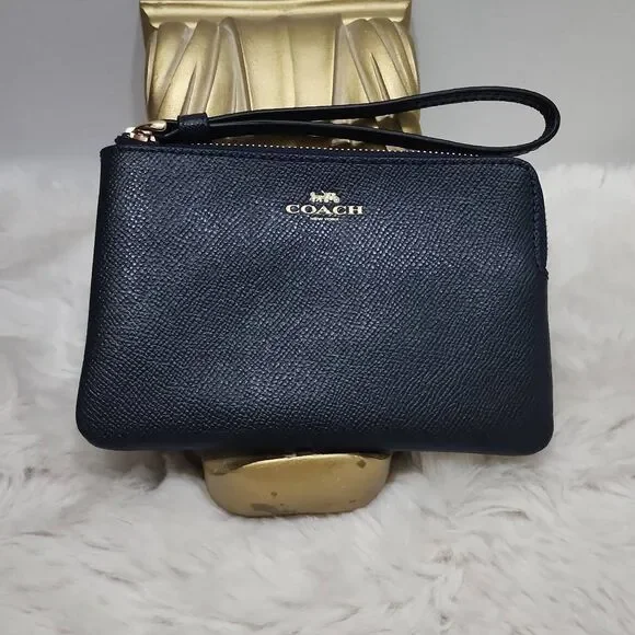 Coach Corner Zip Wristlet in crossgrain leather.