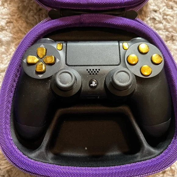 Sony dual shock modified PS4 controller, black and gold with hard case.