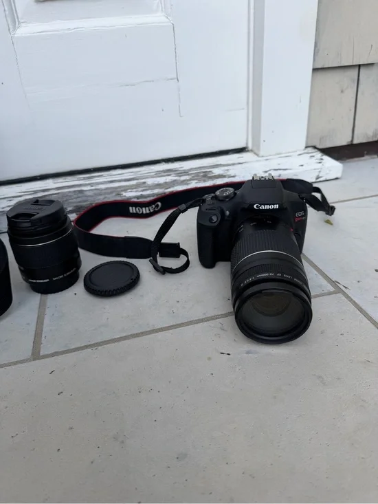 Canon DSLR Camera in Black with Red-Trim Strap and Black Zoom Lens