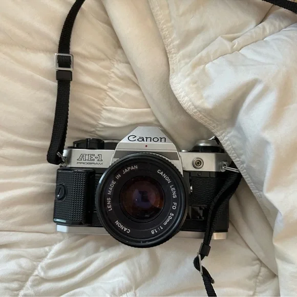 Canon AE-1 35mm Film Camera in Silver and Black with Lens