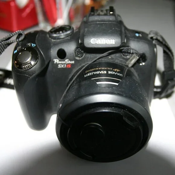 Canon PowerShot SX1 IS video/movie camera with NIB accessories