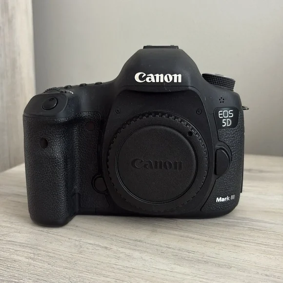 Canon Mark 3 with memory cards, strap, cords, battery and charger and manuals.