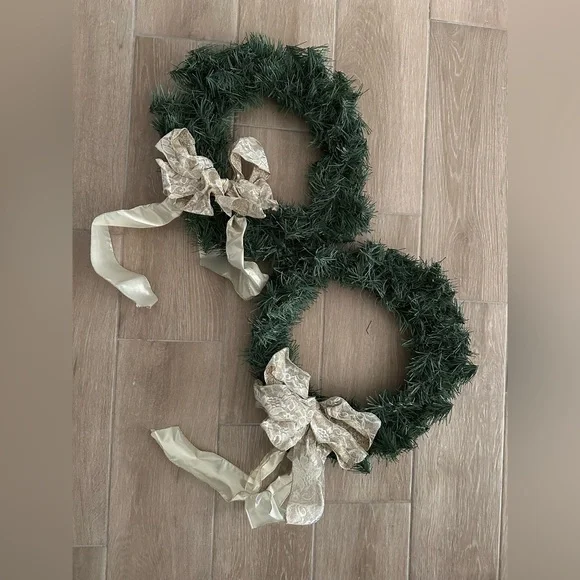 Pair of artificial Christmas wreaths with gold bows