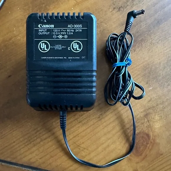 Genuine Canon AD-300S power supply input: 120V ~ 60 Hz 24W output: 13.5V 1.0A