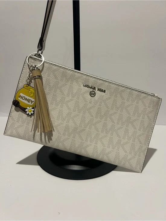 Michael Kors Cream Signature Wristlet with Tassel Charm