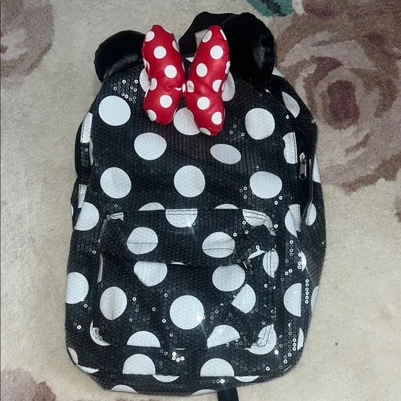 Disney Parks Minnie Mouse polka dot sequin backpack with ears and a red bow.