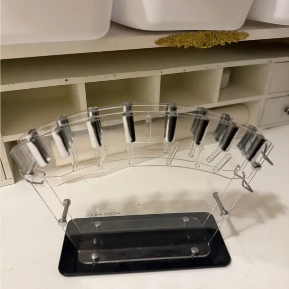 clear acrylic knife block or stand, designed to hold and display kitchen knives.