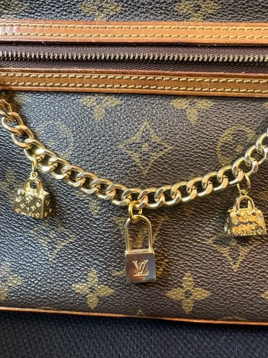 Authentic Louis Vuitton Lock Charm and other unbranded charms on bag chain