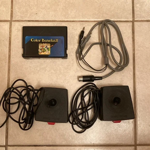 Radio Shack TRS-80 joysticks, game cable, game cartridge and Color Basic manual