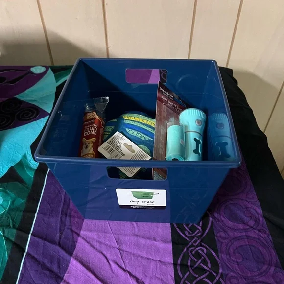 Dog toys in blue storage bin.