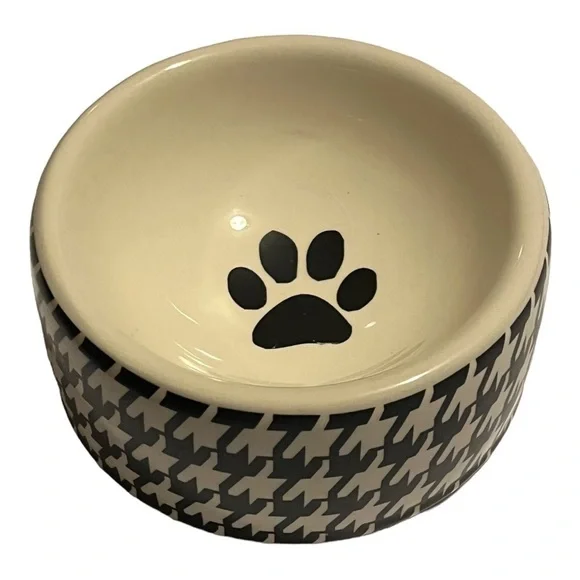 Houndstooth print Ceramic dog bowl black and white paw print inside.