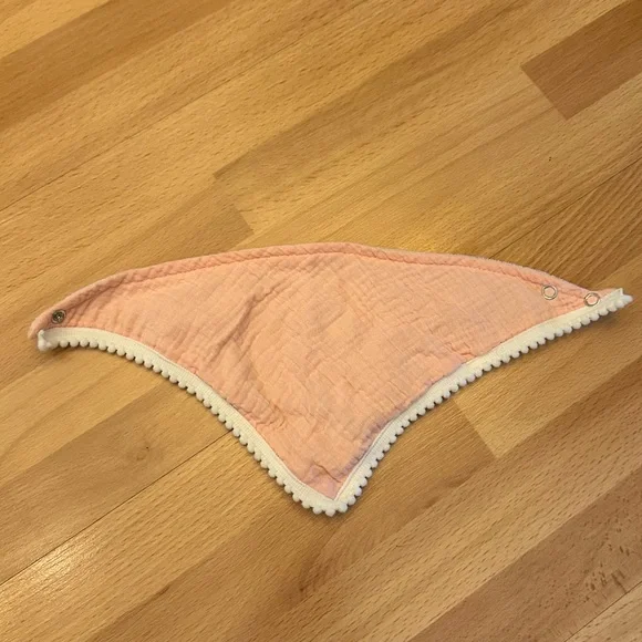 Peachy pink bib with white trim details