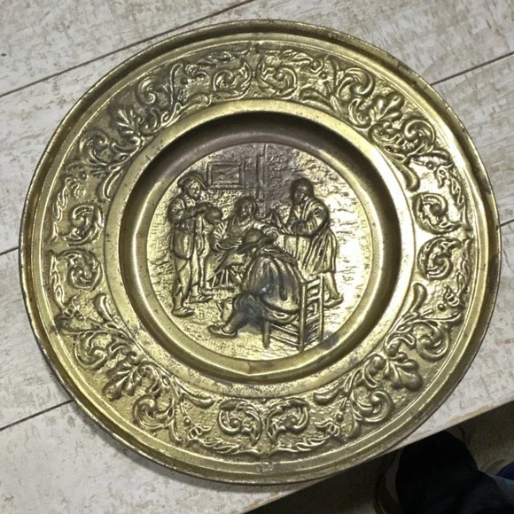 Vintage Brass plate with embossed scene and ornate detailing decorative metal